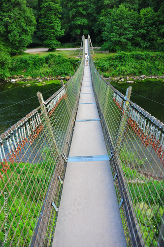 Fototapeta Naklejka Na Ścianę i Meble -  Adventurous footbridge over river