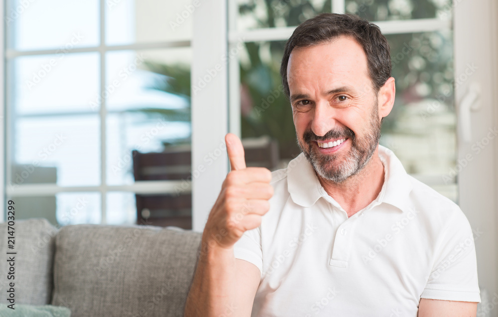 Handsome middle age man happy with big smile doing ok sign, thumb up with fingers, excellent sign Handsome middle age man happy with big smile doing ok sign, thumb up with fingers, excellent sign