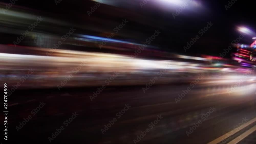 Nighttime street lights streak by (Loop). Nighttime street lights streak by (Loop).