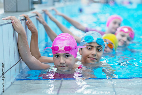 happy kids at the swimming pool. young and successful swimmers pose. © FS-Stock