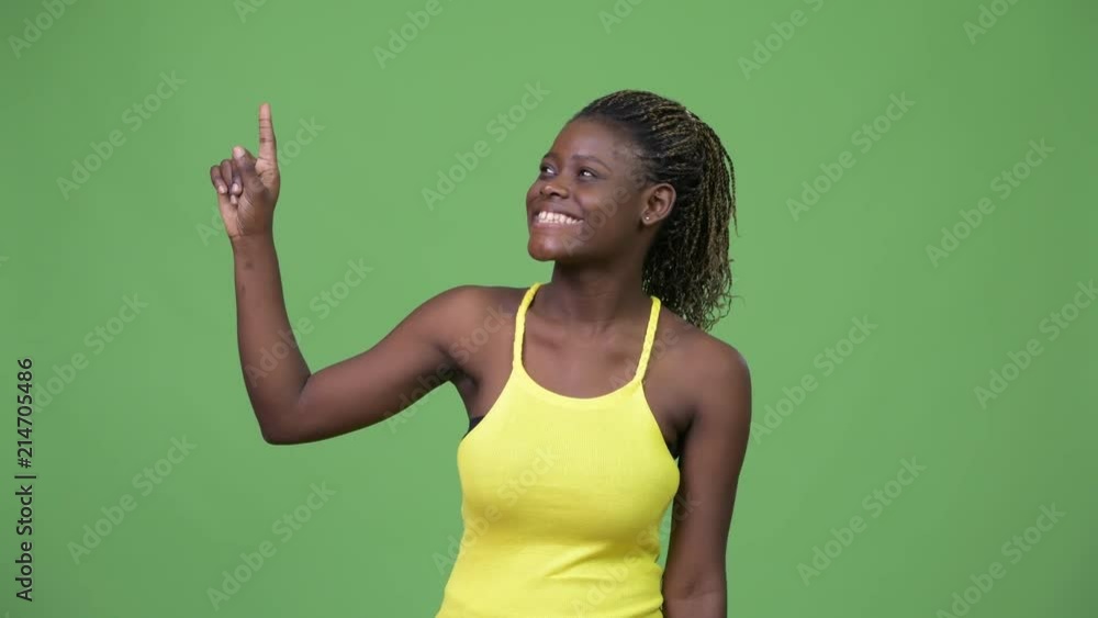 Young African woman pointing up Young African woman pointing up
