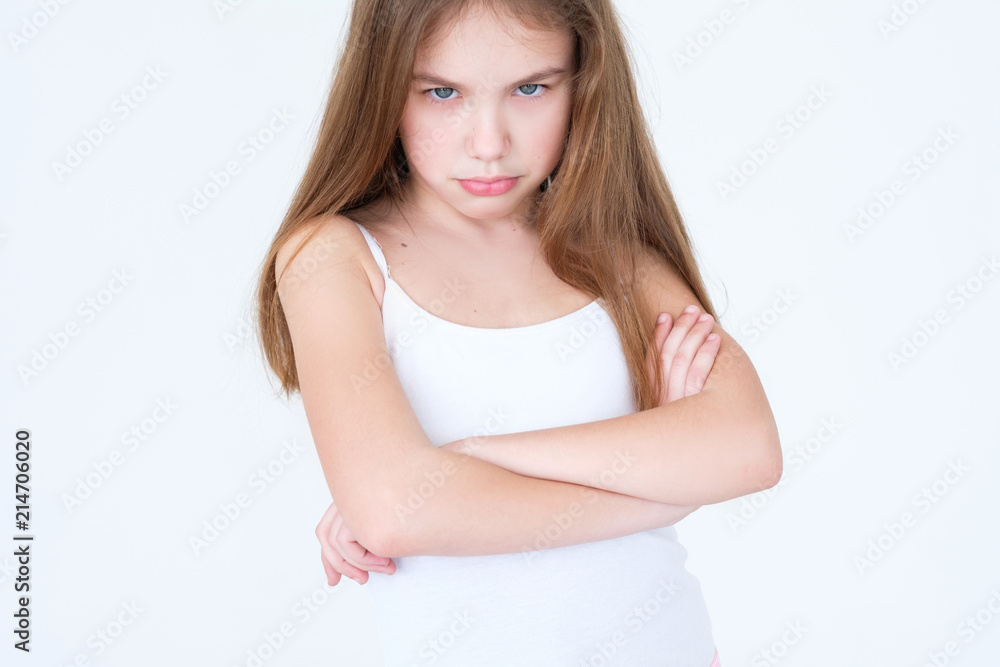 emotion face. child making a hurt look. offended capricious kid with her arms crossed. little girl portrait on white background. mood feelings personality and facial expression concept emotion face. child making a hurt look. offended capricious kid with her arms crossed. little girl portrait on white background. mood feelings personality and facial expression concept