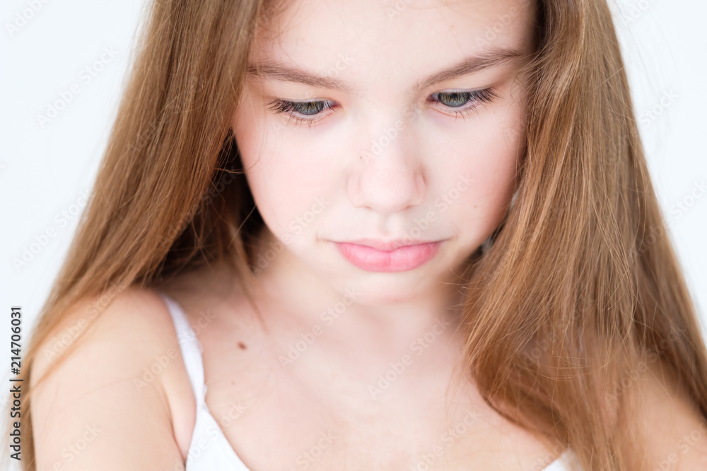 emotion face. sad hurt offended child with pursed lips. little girl portrait on white background. mood feelings personality and facial expression concept emotion face. sad hurt offended child with pursed lips. little girl portrait on white background. mood feelings personality and facial expression concept