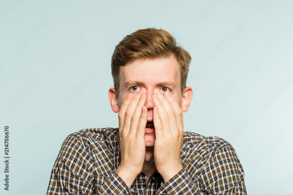 Portrait Of Young Man In Shock With A Scared Face Expression