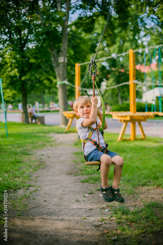 Boy climbing pass obstacles in rope park