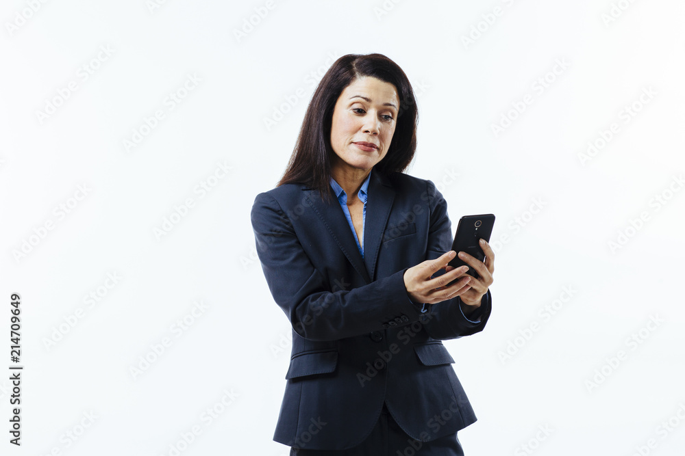 Portrait of business woman reading something on her cell phone, isolated on white studio background Portrait of business woman reading something on her cell phone, isolated on white studio background