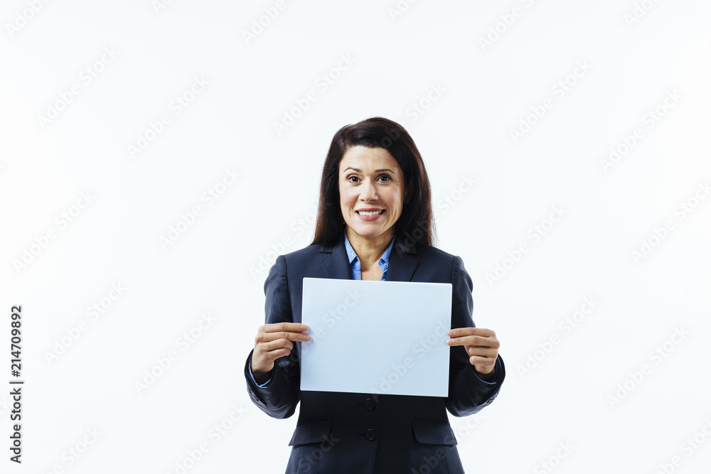 Portrait of a satisfied, smiling woman in grey jacket holding blank sign, isolated on white studio background Portrait of a satisfied, smiling woman in grey jacket holding blank sign, isolated on white studio background