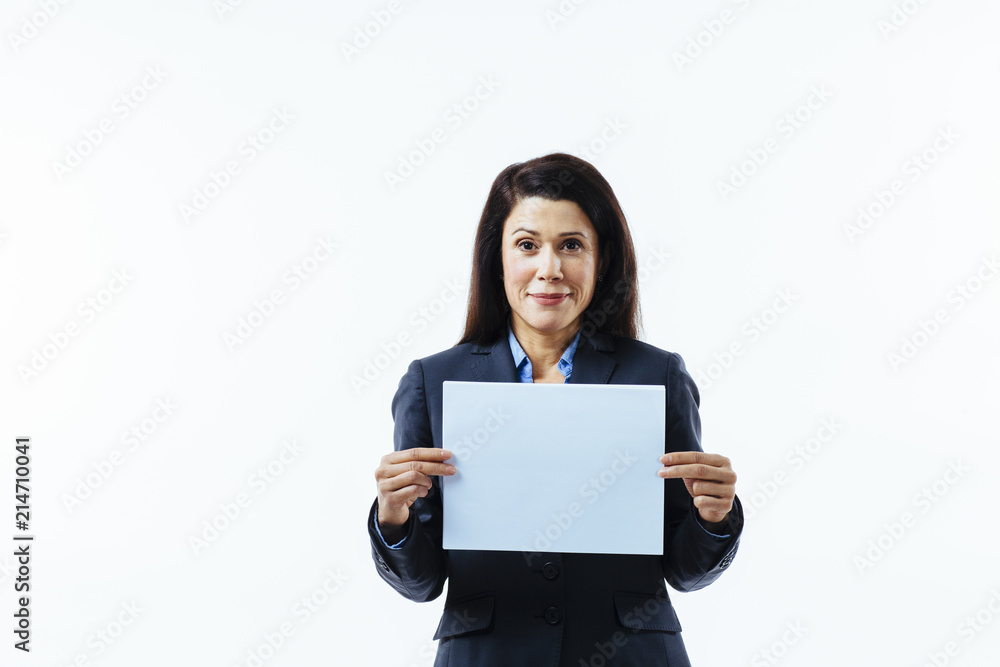 Portrait of a pleasant woman in grey jacket holding blank sign, isolated on white studio background Portrait of a pleasant woman in grey jacket holding blank sign, isolated on white studio background