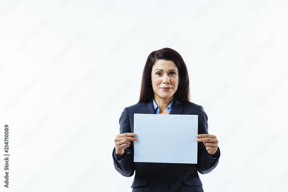 Portrait of a positive woman in grey jacket holding blank sign, isolated on white studio background Portrait of a positive woman in grey jacket holding blank sign, isolated on white studio background