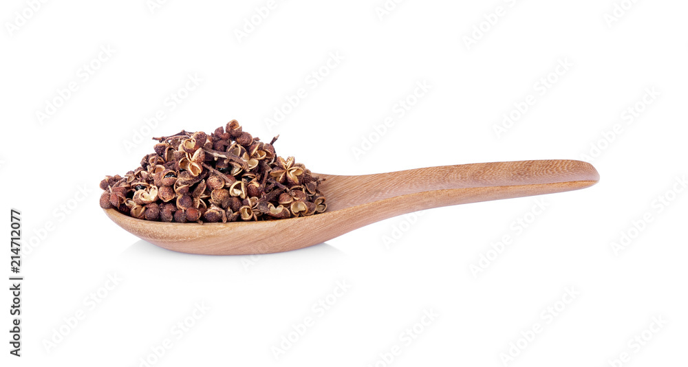 Dry Zanthozylum limonella Alston in wooden spoon on white background. Dry Zanthozylum limonella Alston in wooden spoon on white background.
