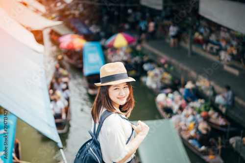 Young asian woman traveler visiting in Damnoen Saduak floating market is the most famous traditional floating market in Thailand at Damnoen Saduak district in Ratchaburi province near Bangkok Thailand photo