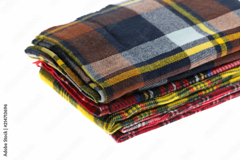 Scarf. checkered warm scarves pile isolated on white background. Scarf. checkered warm scarves pile isolated on white background.