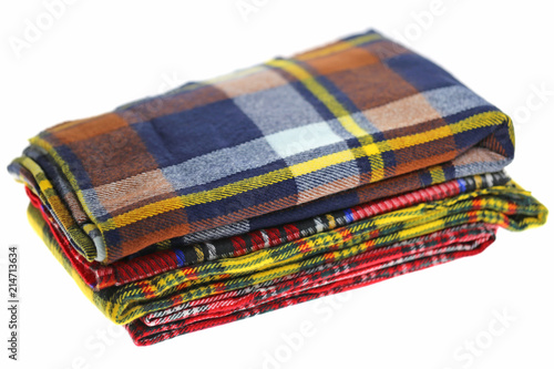 Scarf. checkered warm autumn scarves pile isolated on white background.
