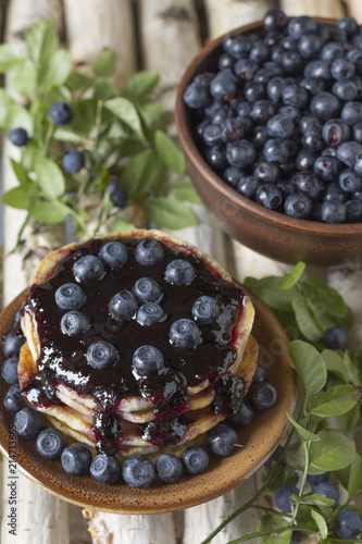 Pancakes with blueberry jam and blueberries .