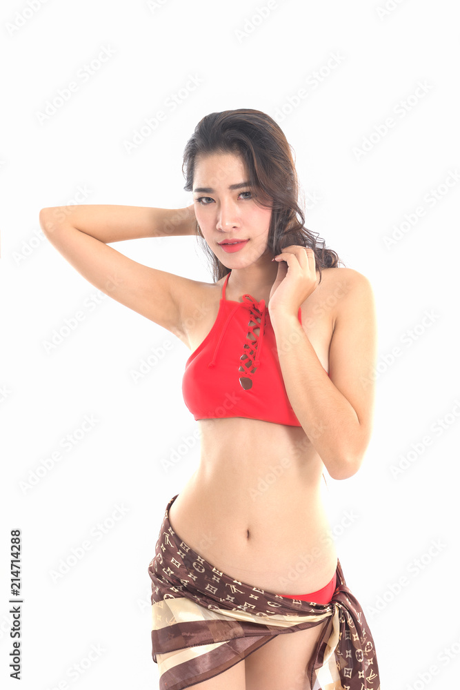Fototapeta premium Asian girl, 20-25 years old, wearing red swimsuit, hands outstretched hair, happy mood on white background.