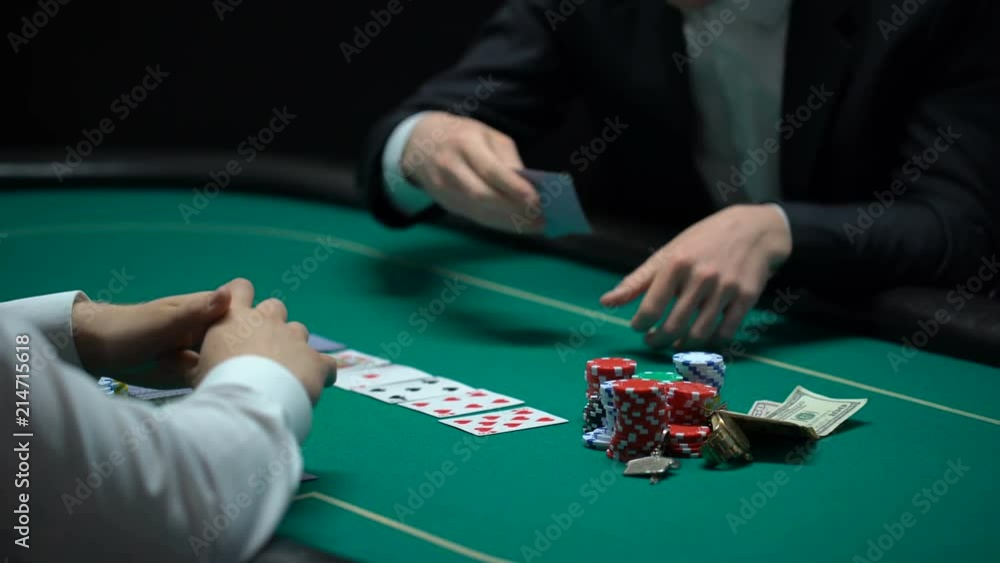 Happy casino player checking cards, taking chips and money, fortunate winner Happy casino player checking cards, taking chips and money, fortunate winner