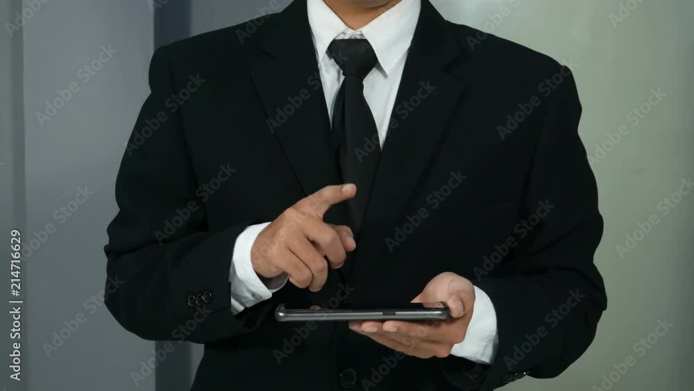 4k of business man holding smartphone and hand touching to virtual touch screen 4k of business man holding smartphone and hand touching to virtual touch screen