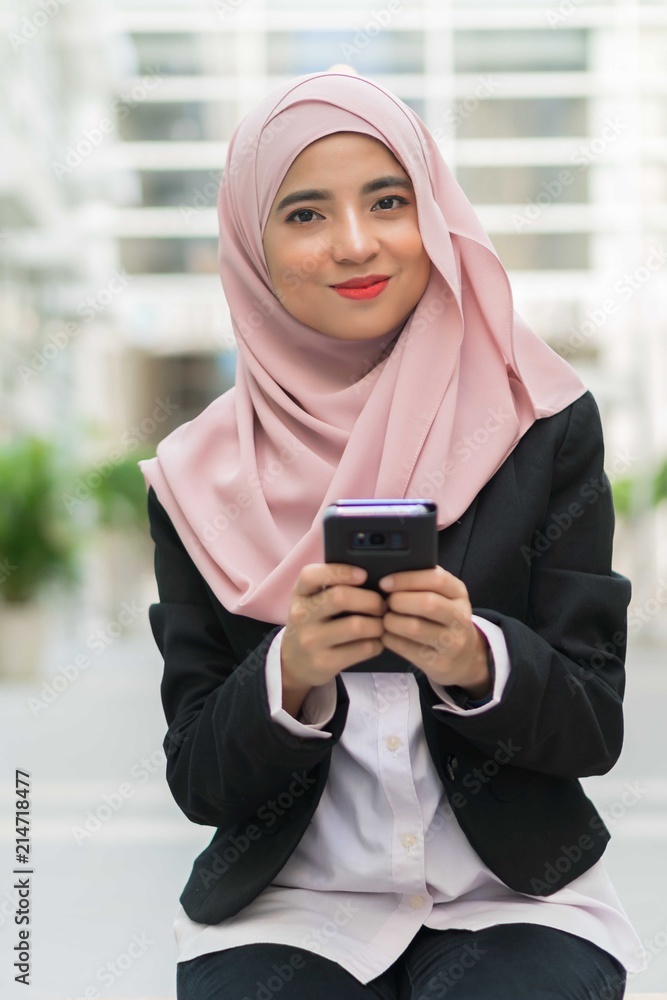 Beautiful Malay girl holding mobile phone outdoor Beautiful Malay girl holding mobile phone outdoor
