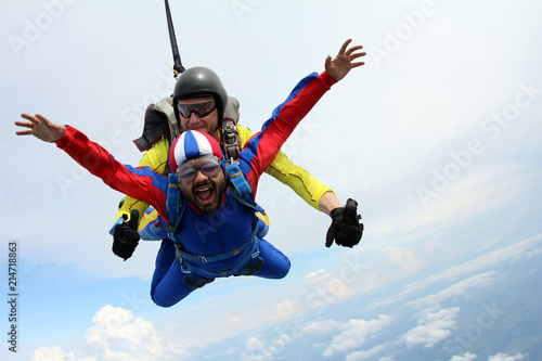Tandem skydiving. Indian man is in the sky.