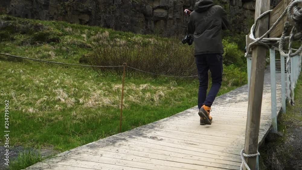guy walking in super slow motion with camera low angle shot gimbal shot