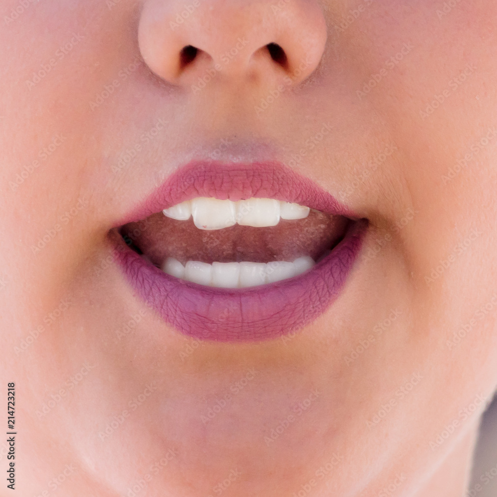 Fototapeta premium The girl's mouth speaks. Macro
