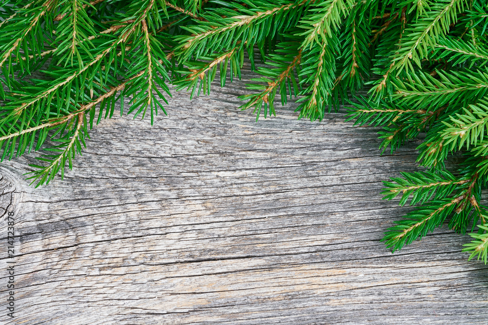 Christmas tree branches on wooden background. Copy space, top view Christmas tree branches on wooden background. Copy space, top view