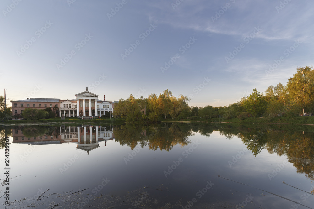 Moscow, Russia. Reflections of main building and trees in the pond. The Main Botanical Garden named after N.V. Tsitsin of Russian Academy of Sciences