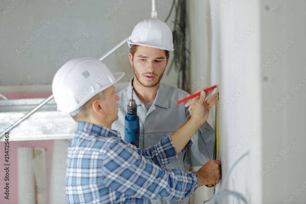 engineer builder talking to co-worker engineer builder talking to co-worker