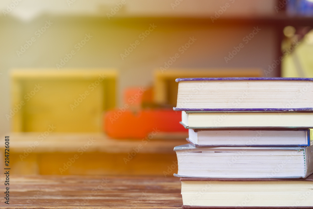 Education and reading concept - group of stack books on the wooden table with copy space for text. Home school concept. Learning at home with parent. Education and reading concept - group of stack books on the wooden table with copy space for text. Home school concept. Learning at home with parent.