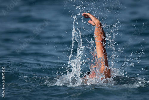 Man swimmer swimming crawl in blue sea,training for triathlon