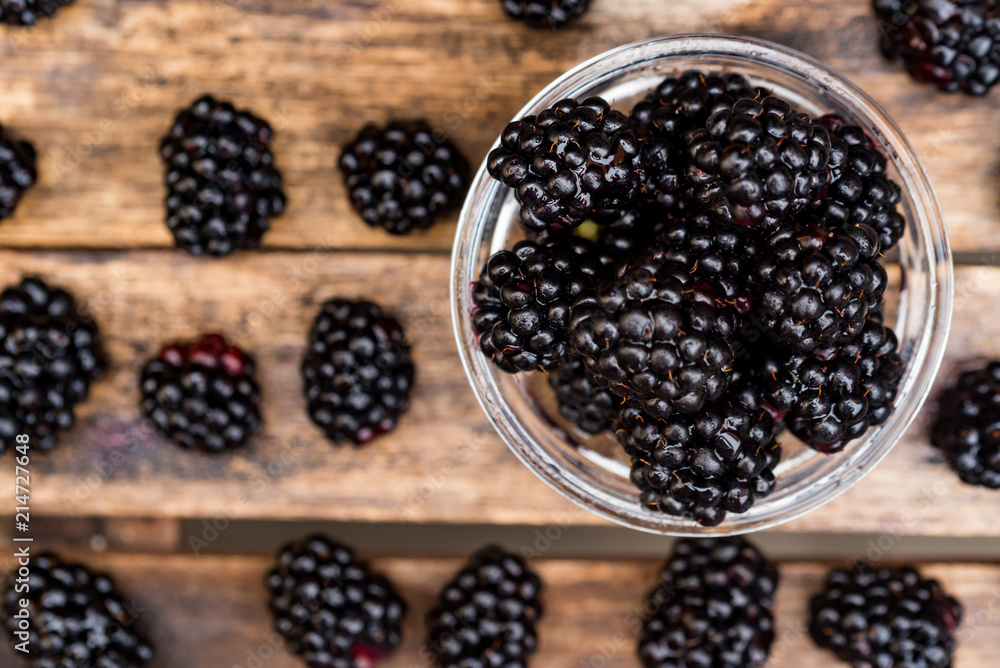 Fresh ripe blackberries in bowl on wooden table Fresh ripe blackberries in bowl on wooden table