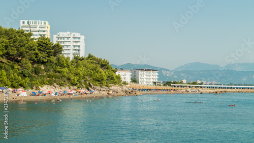 Albanian Adriatic sea beach. Sea coast beach people relaxing. Nature with man made buildings.