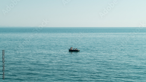 Small boat in the middle of the see fishing. Quite place peaceful. Adriatic see Albania © Igli