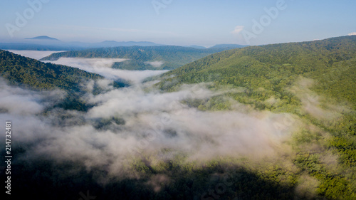 4K Epic Aerial Flight Through Mountain Clouds on Sunrise Beautiful Morning. Peaks Inspirational Motivational Nature Background.