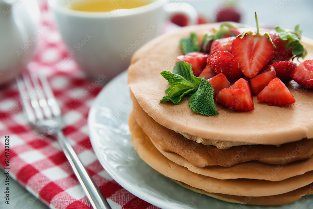 Plate with delicious pancakes and strawberries on table, closeup Plate with delicious pancakes and strawberries on table, closeup