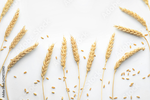 Wheat grains with spikelets on white background