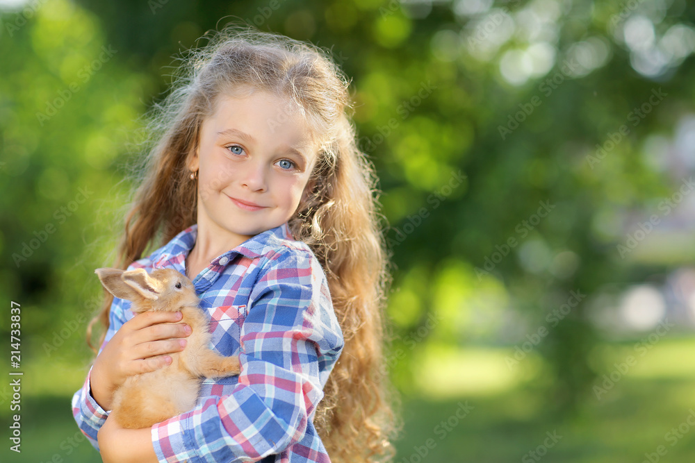 Girl with a cute little rabbit, outdoor, summer day Girl with a cute little rabbit, outdoor, summer day