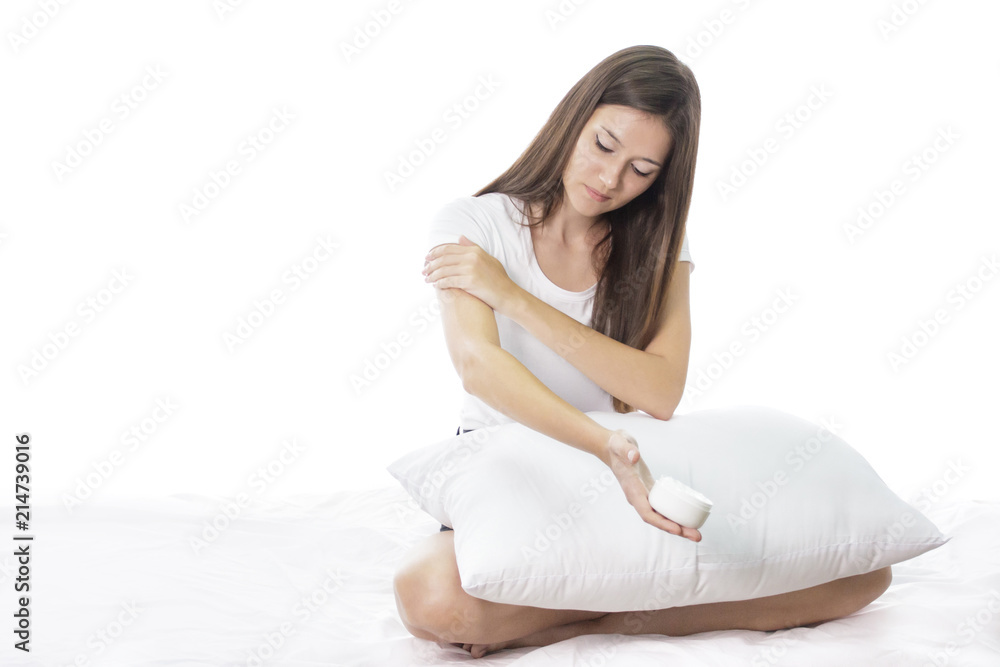 beautiful girl applying body lotion to her arm beautiful girl applying body lotion to her arm