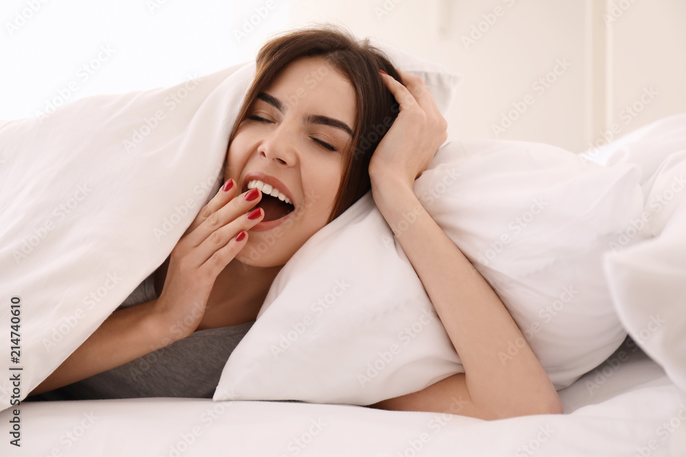 Morning of sleepy young woman lying in bed Morning of sleepy young woman lying in bed