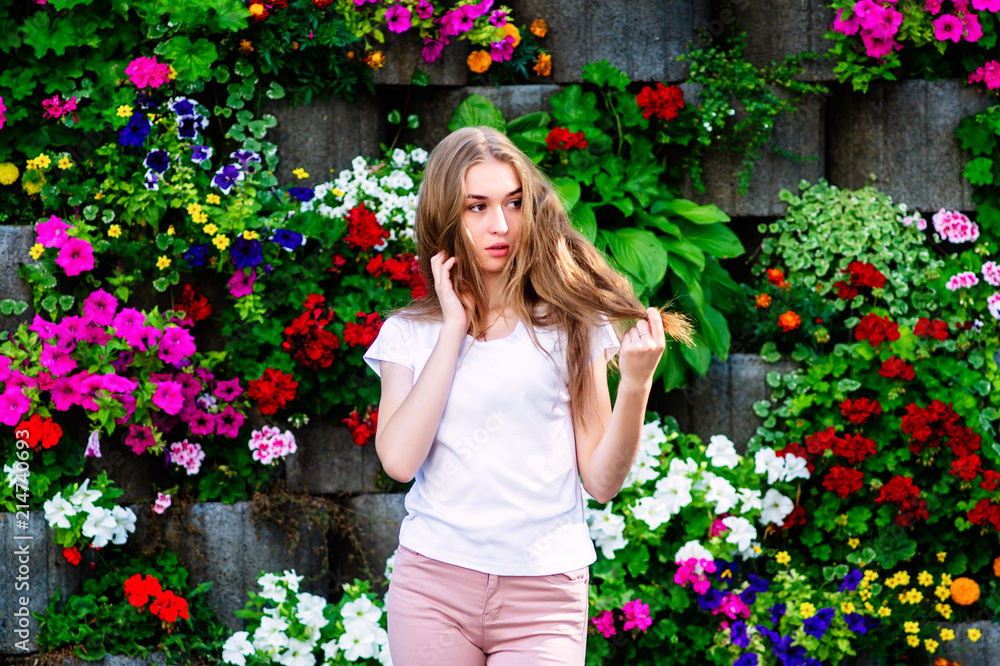 A young girl stands in a circle of flowers. A young girl stands in a circle of flowers.