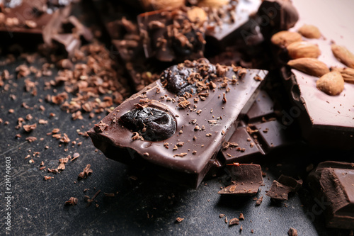 Fototapeta Naklejka Na Ścianę i Meble -  Pieces of chocolate with almonds and dried fruits on table