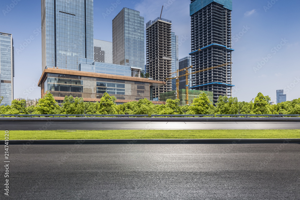 Panoramic skyline and modern business office buildings with empty road,empty concrete square floor Panoramic skyline and modern business office buildings with empty road,empty concrete square floor