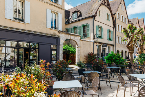 Old street with old houses and tables of cafe in a small town Chartres, France © Ekaterina Belova