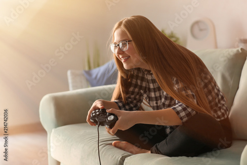 Cute girl playing video gam...