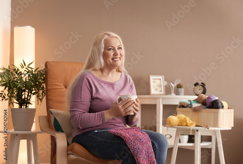 Mature woman resting at hom...