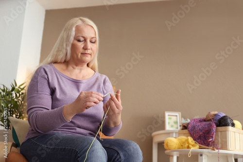 Mature woman sitting in arm...