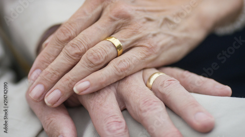 Portrait of older senior hands with wedding rings on  photo