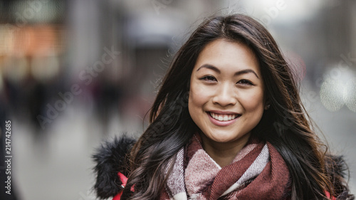 Obraz na plátně Portrait of attractive and happy smiling young Asian woman looking to camera on
