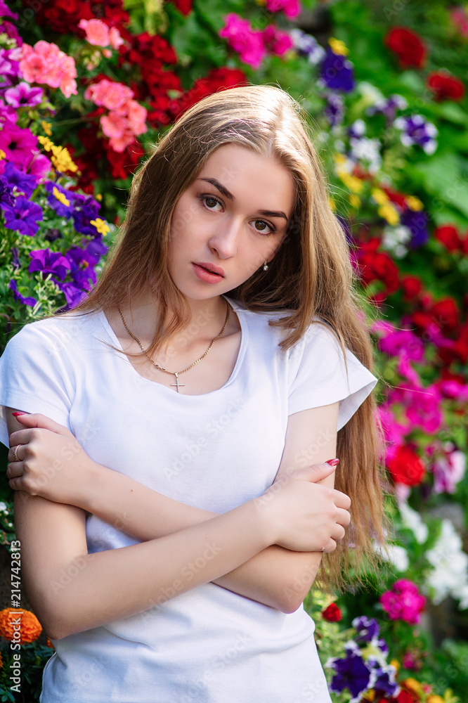 Portrait of a young girl in a circle of flowers. Portrait of a young girl in a circle of flowers.