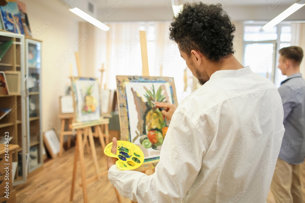 African-American artist painting still life in workshop African-American artist painting still life in workshop